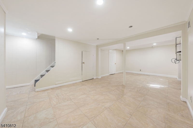 985 Arnet Avenue Union, NJ 07083 - Photo 13 of 26 an empty room with white walls and tiles