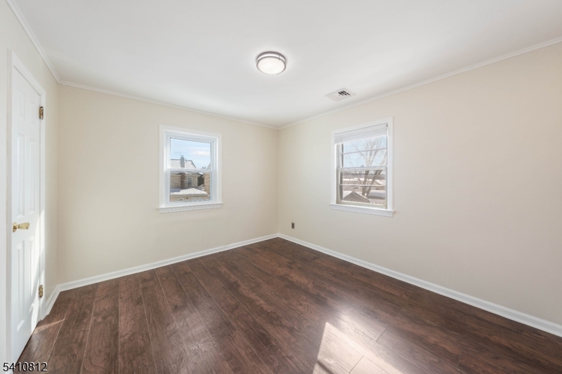 985 Arnet Avenue Union, NJ 07083 - Photo 3 of 26 an empty room with wooden floor and windows