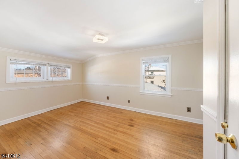 985 Arnet Avenue Union, NJ 07083 - Photo 5 of 26 an empty room with wooden floor and windows