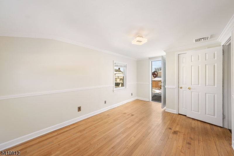 985 Arnet Avenue Union, NJ 07083 - Photo 6 of 26 a view of an empty room with wooden floor and a window