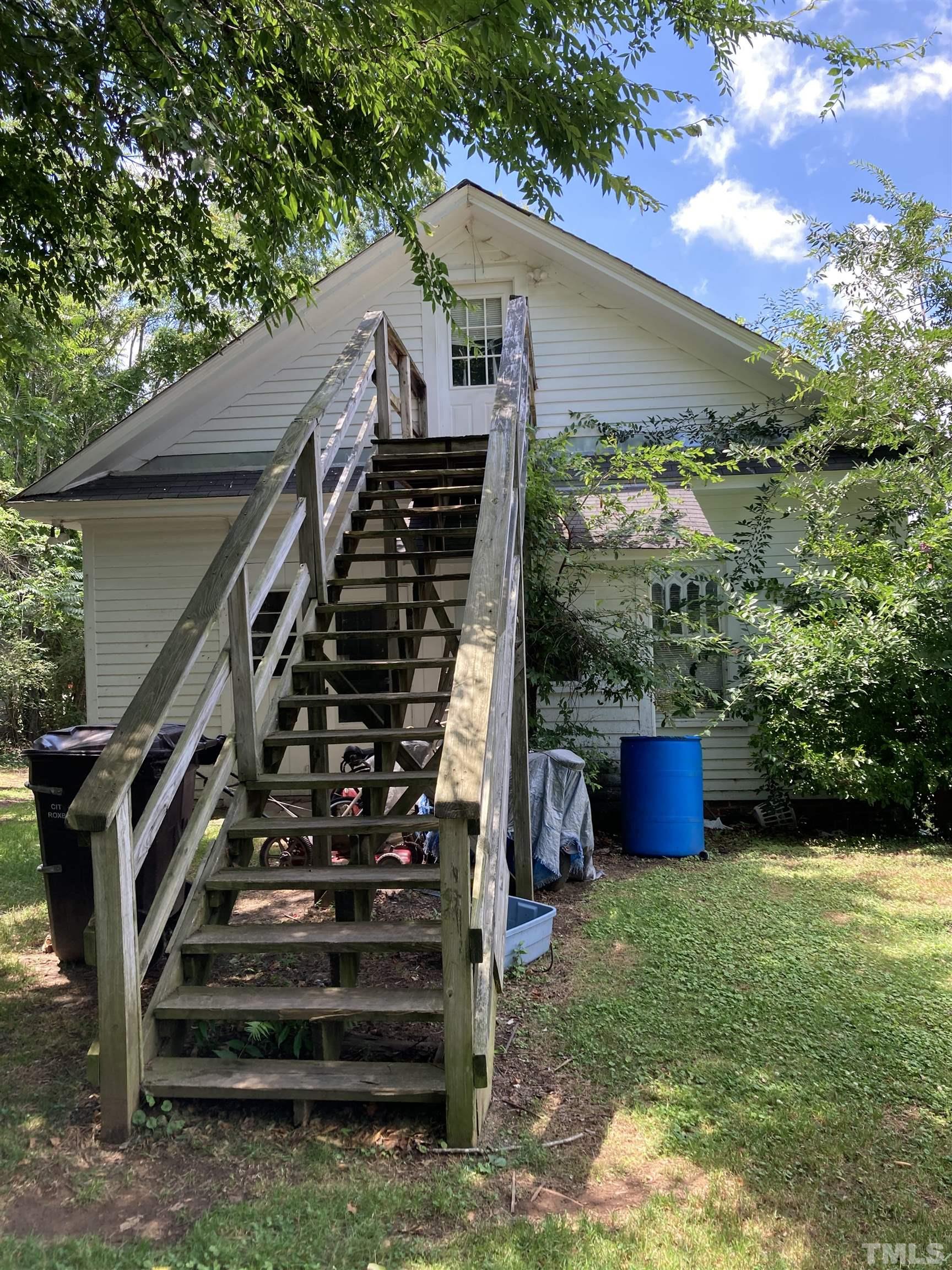 526 South Main Street Roxboro, NC 27573 - Photo 4 of 6 a view of a house with backyard porch and wooden fence