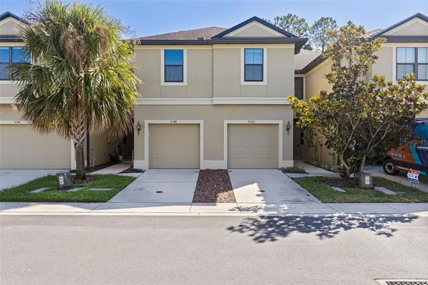 a front view of house with yard and green space