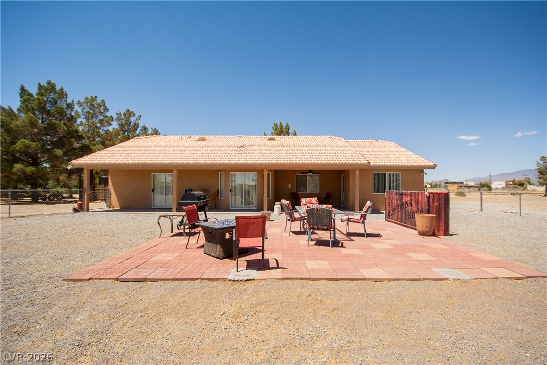 2381 Tough Boy Road Pahrump, NV 89060 - Photo 26 of 44 This spacious backyard offers ample outdoor living with a tiled patio perfect for gatherings.