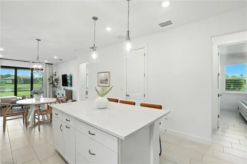 a room with a table chairs and projector