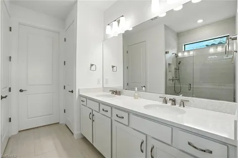 a spacious bathroom with a double vanity sink mirror and double