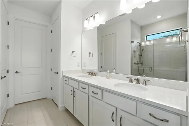 a spacious bathroom with a double vanity sink mirror and double