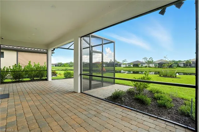 a kitchen with white cabinets and sink