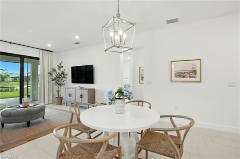 a living room with furniture a flat screen tv and a large window
