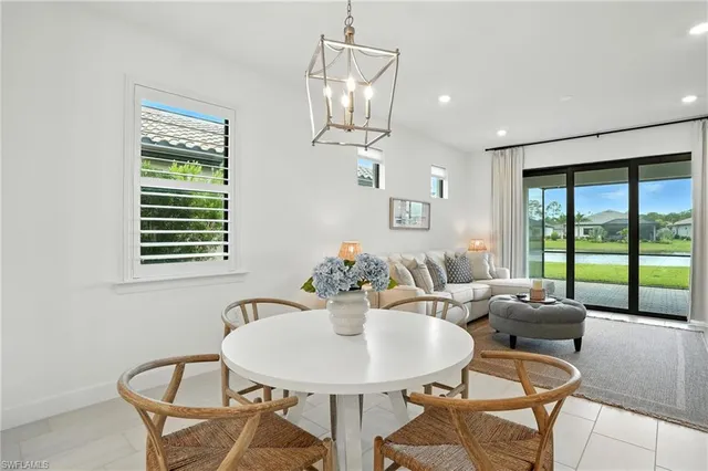 a view of a dining room with furniture wooden floor and a chandelier
