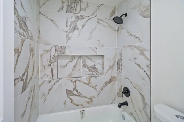 a bathroom with a bathtub and shower