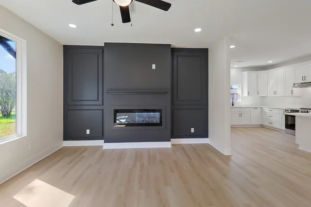a view of a room with an empty space and a kitchen
