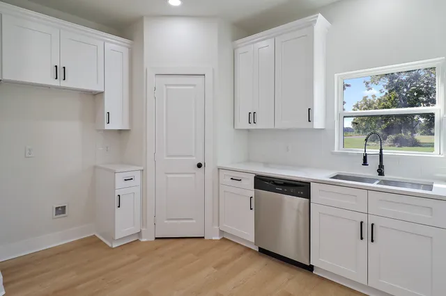 a kitchen with a sink cabinets and window