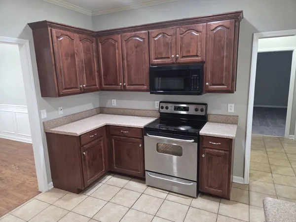 a kitchen with granite countertop a sink and a stove