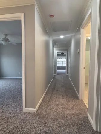wooden floor in a hall with a bathroom