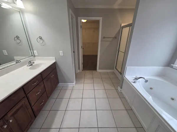 a bathroom with a bathtub sink vanity and a mirror