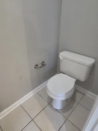 a white toilet sitting next to a shower