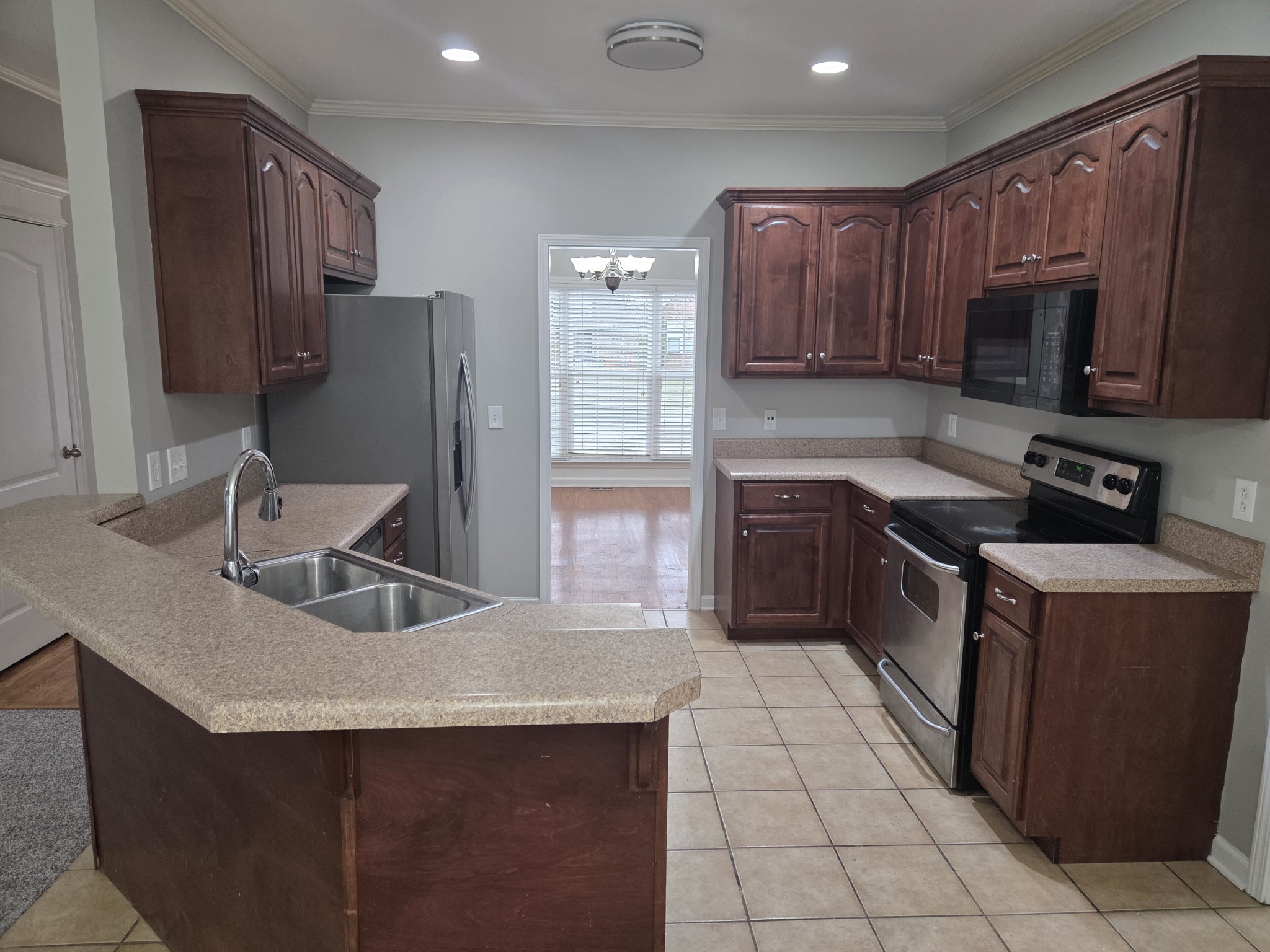617 Rambush Drive Murfreesboro, TN 37128 - Photo 9 of 32 a kitchen with stainless steel appliances granite countertop a sink stove microwave and refrigerator