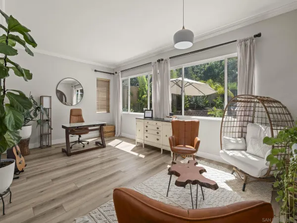 a living room with furniture a potted plant and a wooden table
