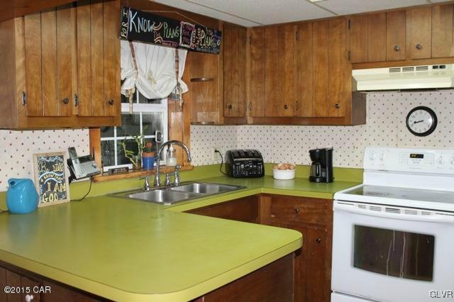 552 Interchange Road Kunkletown, PA 18058 - Photo 11 of 20 a kitchen with a sink a stove and cabinets