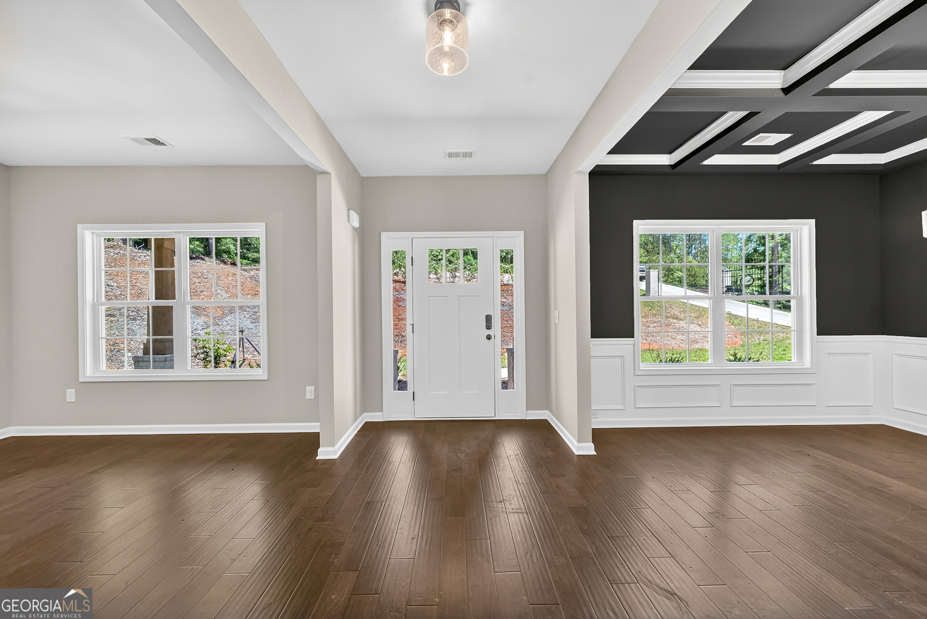 38 Oak Ridge Drive, Unit 26 Waverly Hall, GA 31831 - Photo 6 of 37 a view of an empty room with wooden floor and a window