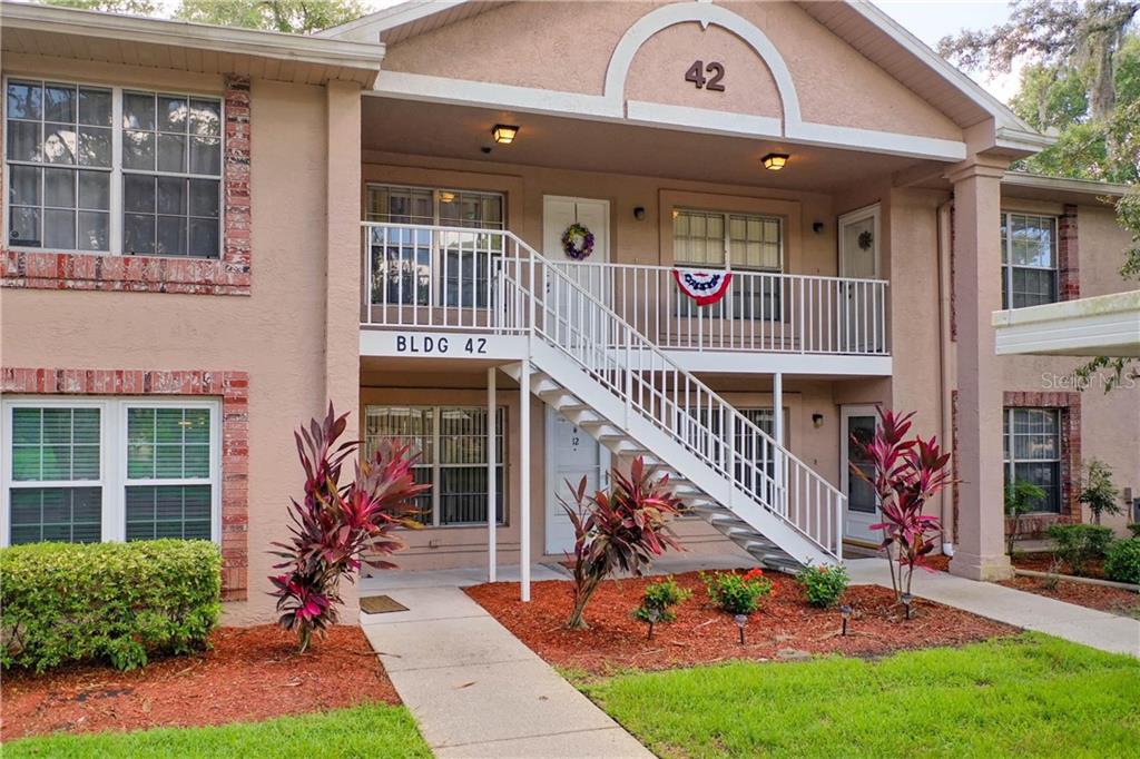 6700 Spring Flower Drive, Unit 12 New Port Richey, FL 34653 - Photo 1 of 1 a front view of a house with a yard