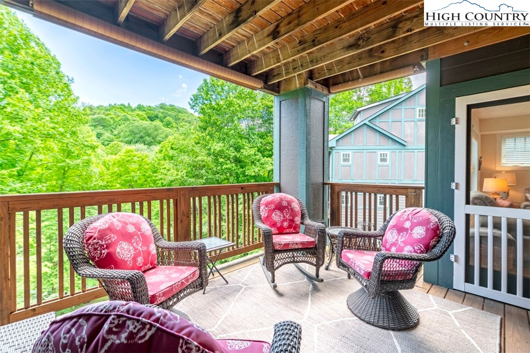 166 Still Lake Drive, Unit 222 Boone, NC 28607 - Photo 13 of 37 a patio with table and chairs and potted plants