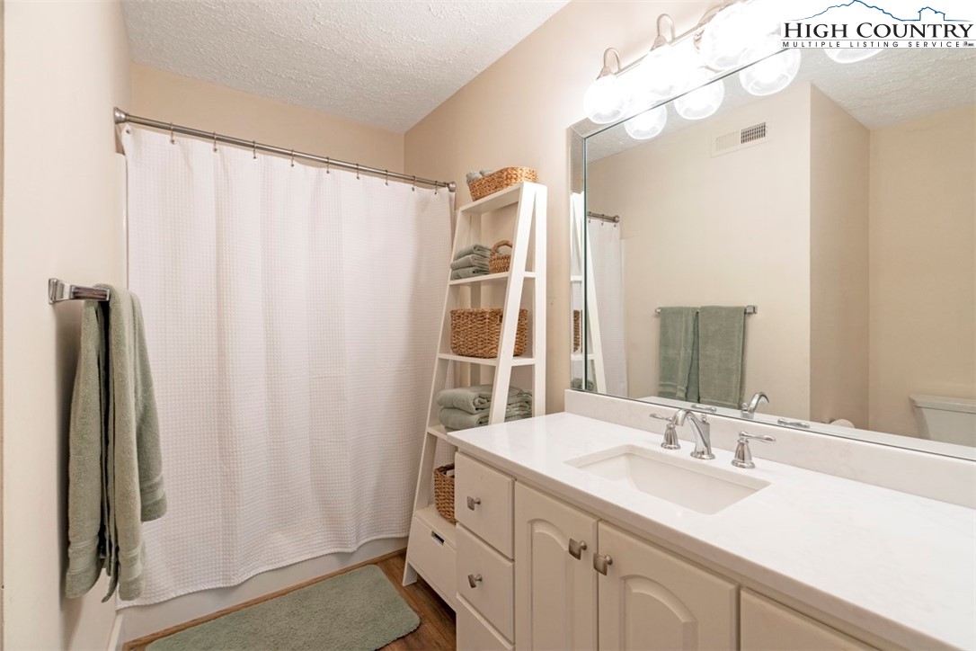 166 Still Lake Drive, Unit 222 Boone, NC 28607 - Photo 22 of 37 a bathroom with a double vanity sink and mirror