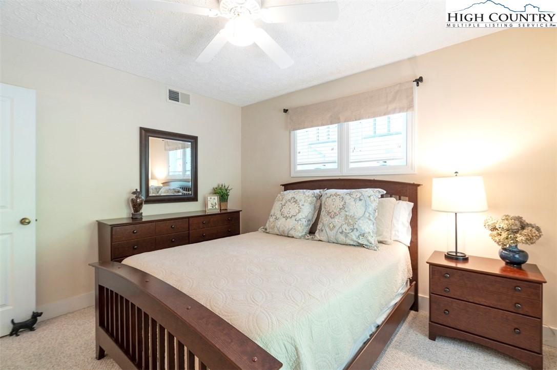 166 Still Lake Drive, Unit 222 Boone, NC 28607 - Photo 24 of 37 a bedroom with a bed and window