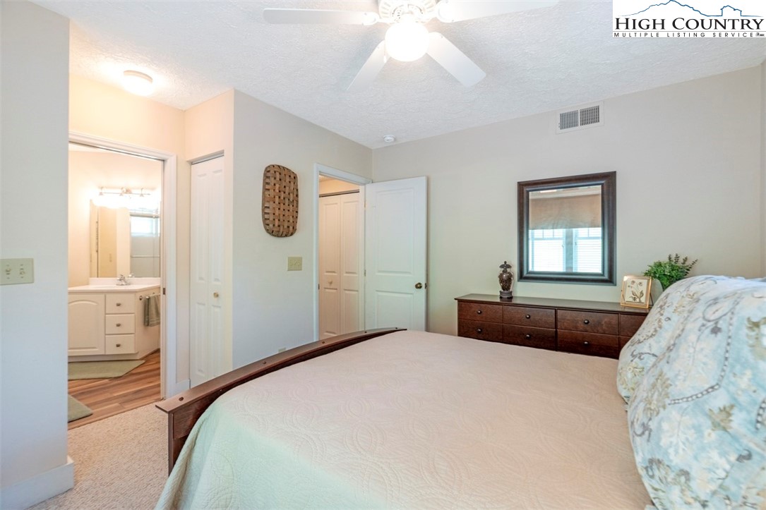 166 Still Lake Drive, Unit 222 Boone, NC 28607 - Photo 25 of 37 a bedroom with a bed and a window