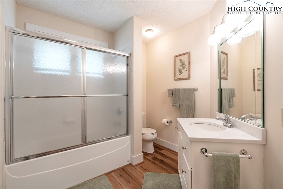 166 Still Lake Drive, Unit 222 Boone, NC 28607 - Photo 27 of 37 a bathroom with a sink a toilet and shower