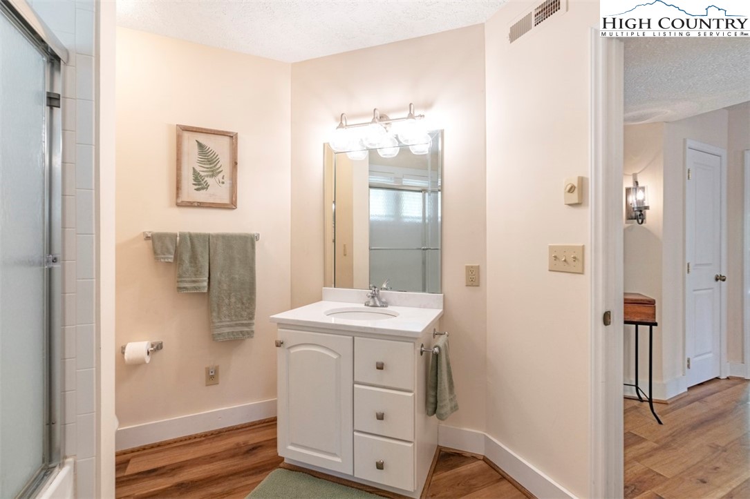 166 Still Lake Drive, Unit 222 Boone, NC 28607 - Photo 28 of 37 a bathroom with a sink and a mirror
