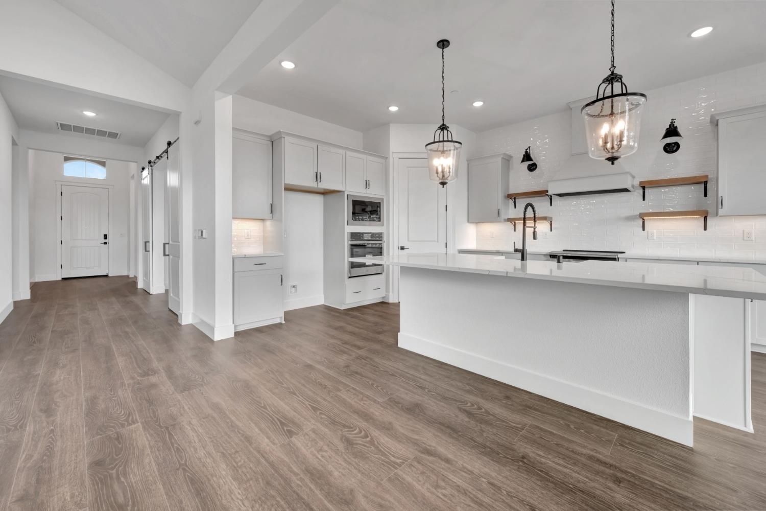 4327 Hooded Crow Way Rancho Cordova, CA 95742 - Photo 14 of 58 a large kitchen with a lot of counter space and stainless steel appliances