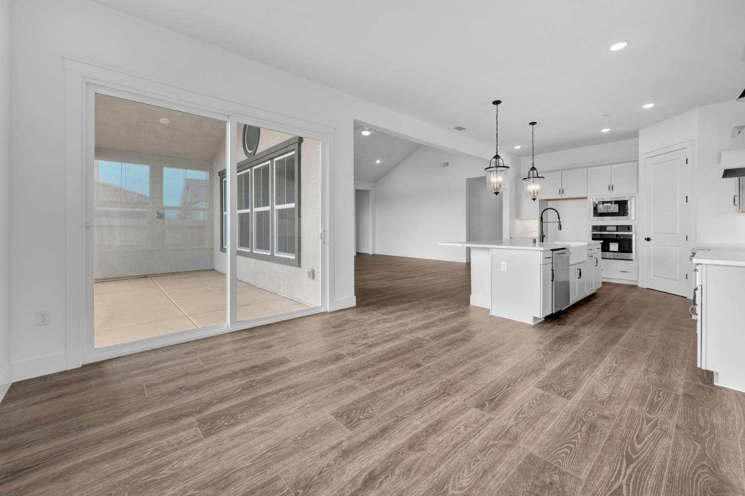 4327 Hooded Crow Way Rancho Cordova, CA 95742 - Photo 15 of 58 a view of a kitchen with wooden floor and window