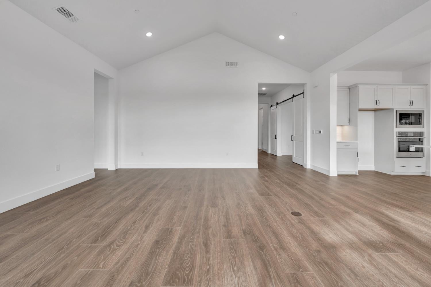 4327 Hooded Crow Way Rancho Cordova, CA 95742 - Photo 16 of 58 a view of empty room with wooden floor
