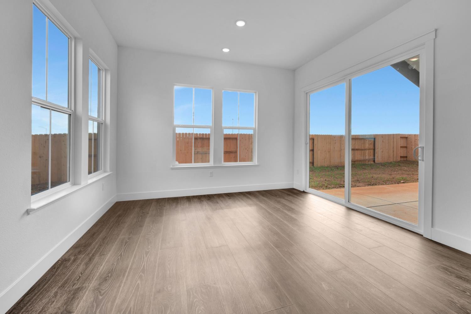 4327 Hooded Crow Way Rancho Cordova, CA 95742 - Photo 22 of 58 a view of an empty room with wooden floor and a window