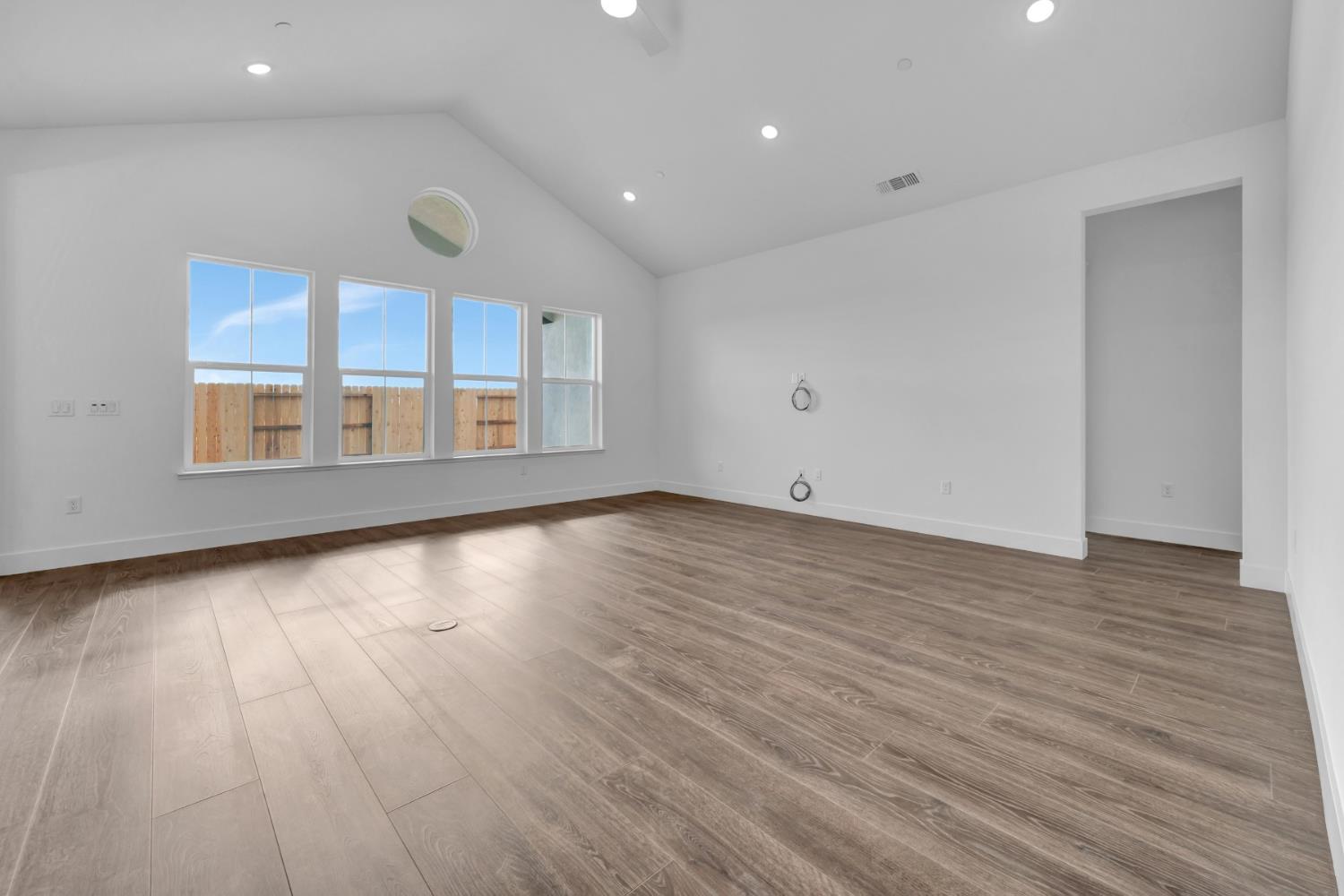 4327 Hooded Crow Way Rancho Cordova, CA 95742 - Photo 24 of 58 an empty room with wooden floor and windows