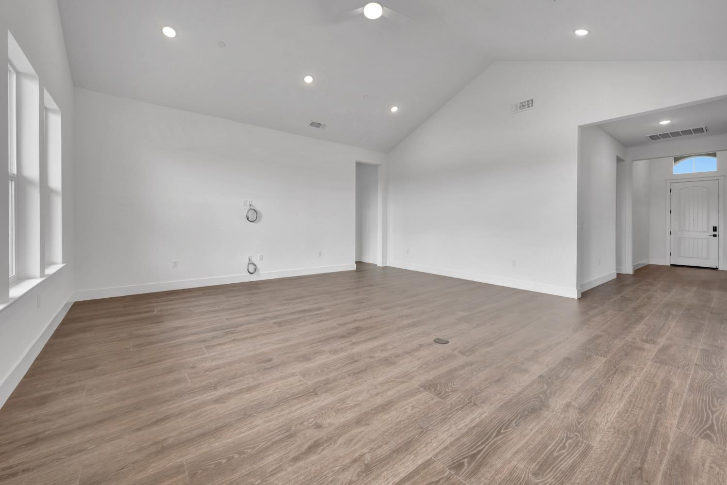 4327 Hooded Crow Way Rancho Cordova, CA 95742 - Photo 25 of 58 an empty room with wooden floor and windows