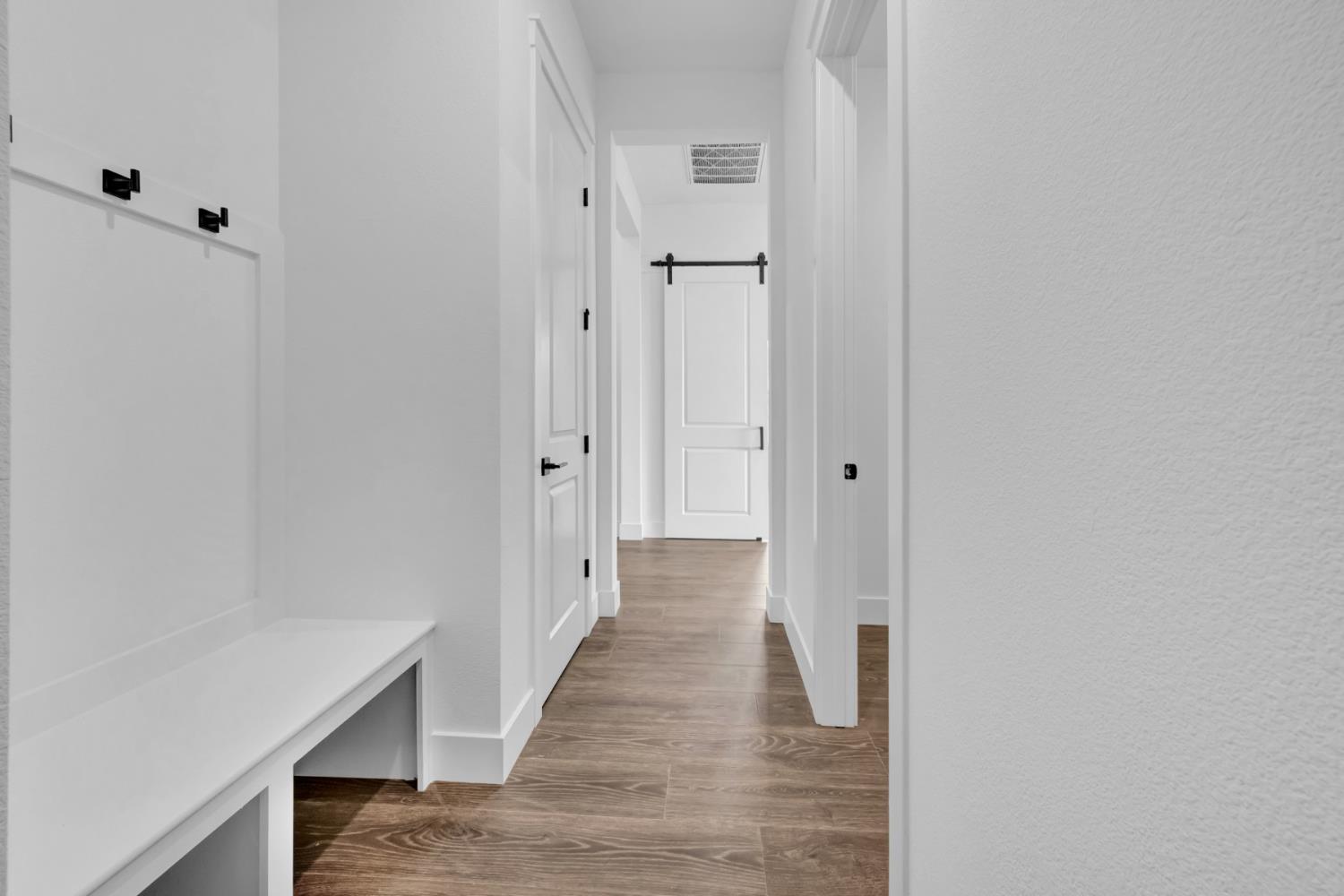 4327 Hooded Crow Way Rancho Cordova, CA 95742 - Photo 27 of 58 a view of a hallway with wooden floor