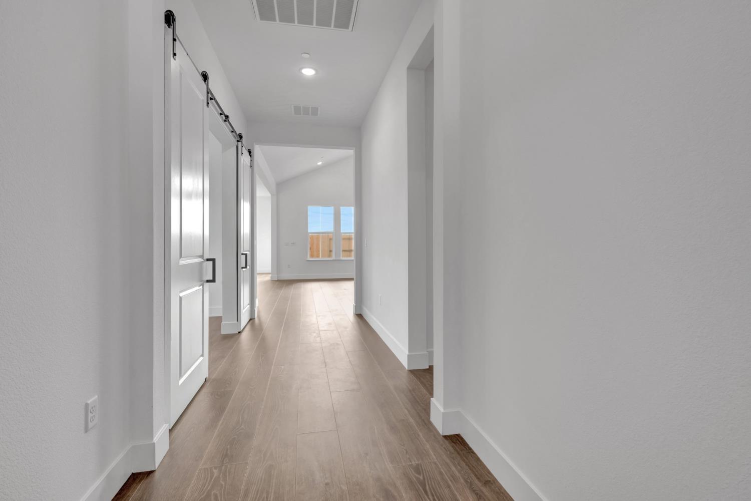 4327 Hooded Crow Way Rancho Cordova, CA 95742 - Photo 28 of 58 a view of a hallway with wooden floor
