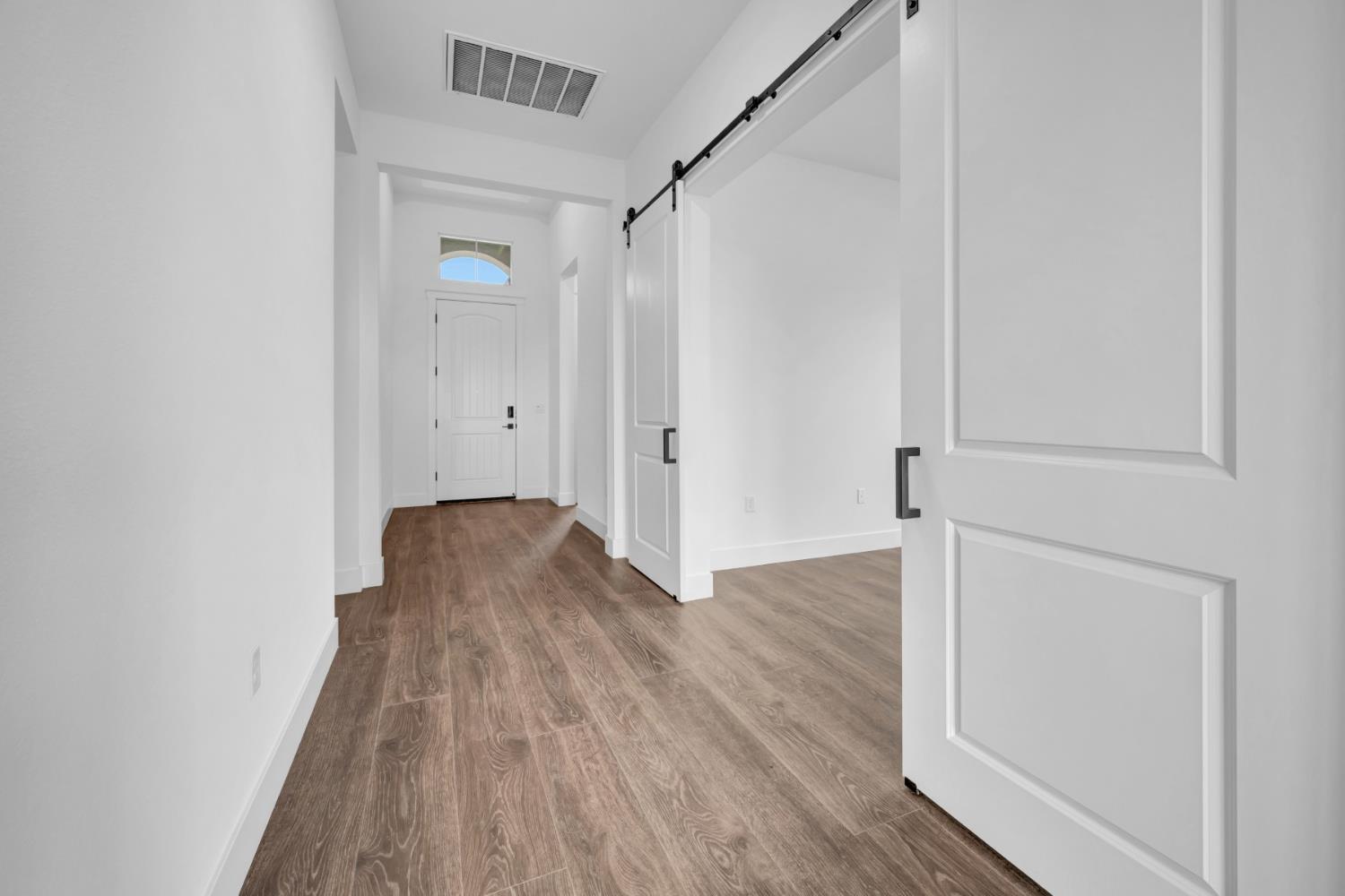 4327 Hooded Crow Way Rancho Cordova, CA 95742 - Photo 29 of 58 a view of a hallway with wooden floor and staircase