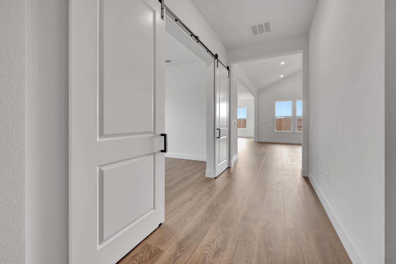4327 Hooded Crow Way Rancho Cordova, CA 95742 - Photo 30 of 58 a view of a hallway with wooden floor