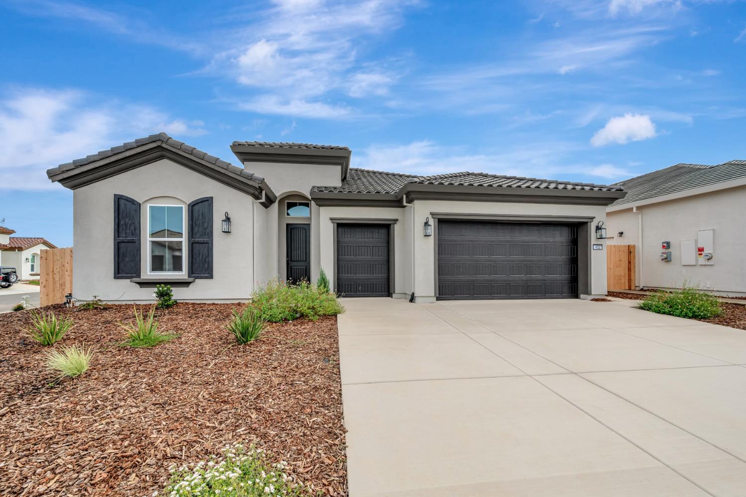 4327 Hooded Crow Way Rancho Cordova, CA 95742 - Photo 3 of 58 a front view of a house with a garden