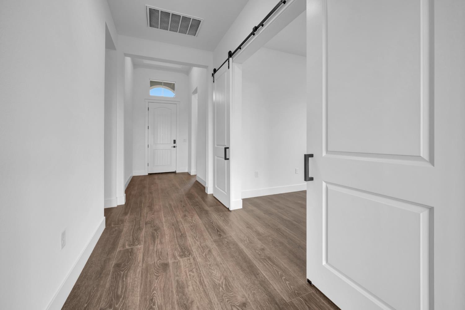 4327 Hooded Crow Way Rancho Cordova, CA 95742 - Photo 31 of 58 a view of a hallway with wooden floor