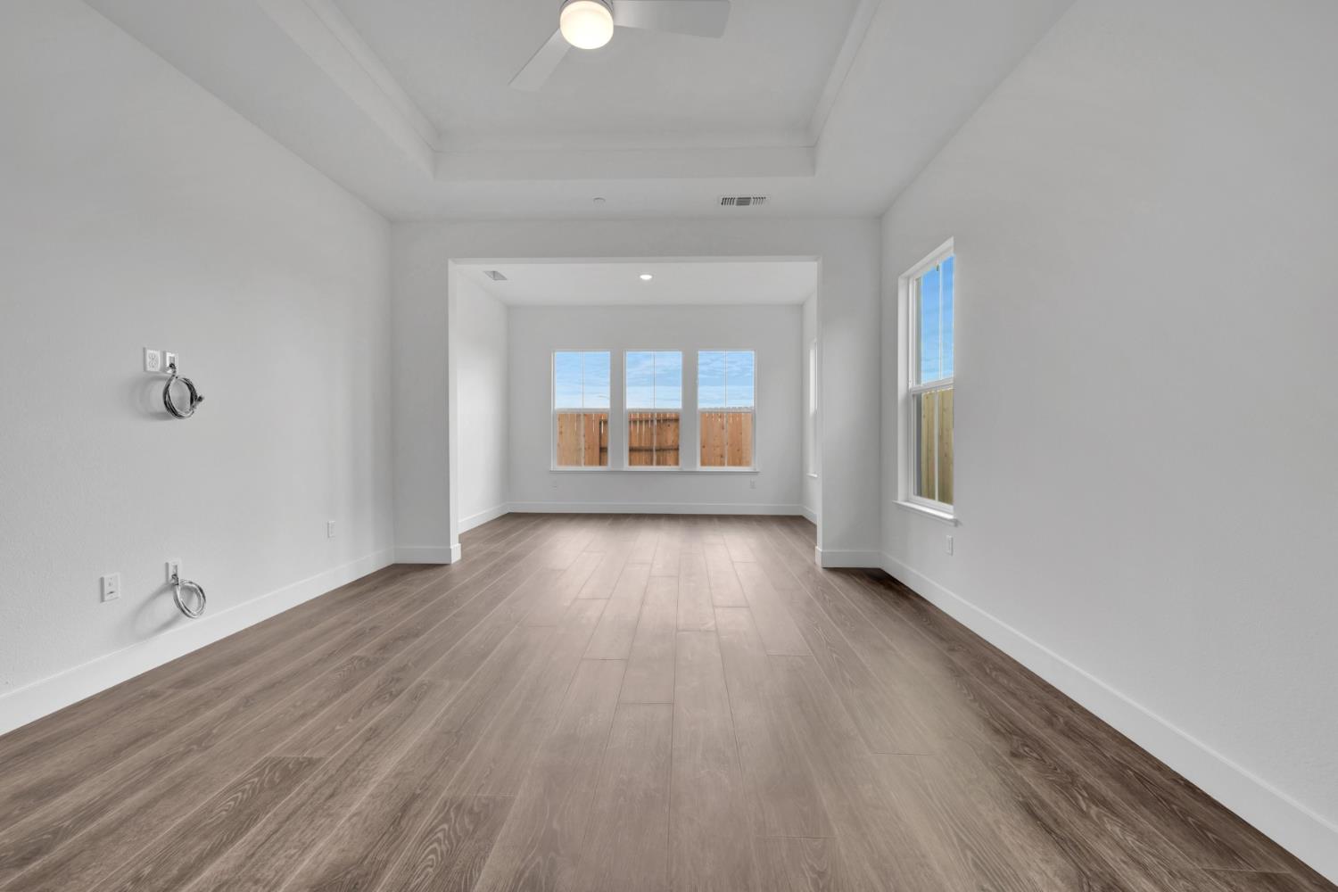 4327 Hooded Crow Way Rancho Cordova, CA 95742 - Photo 39 of 58 an empty room with wooden floor and windows