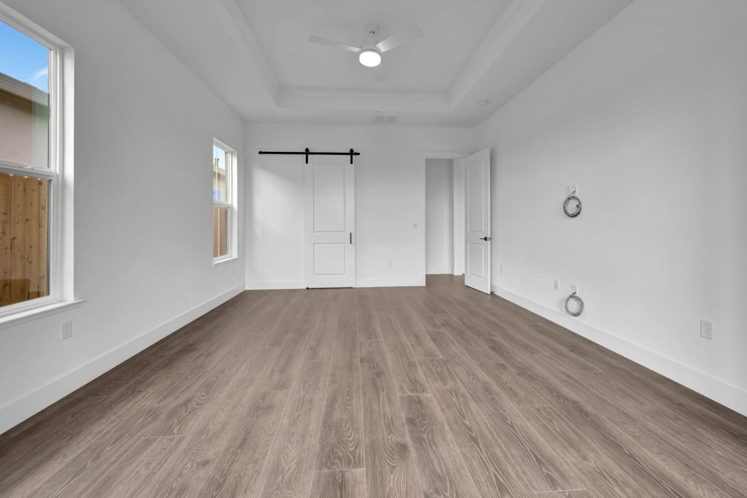 4327 Hooded Crow Way Rancho Cordova, CA 95742 - Photo 41 of 58 a view of empty room with wooden floor and fan