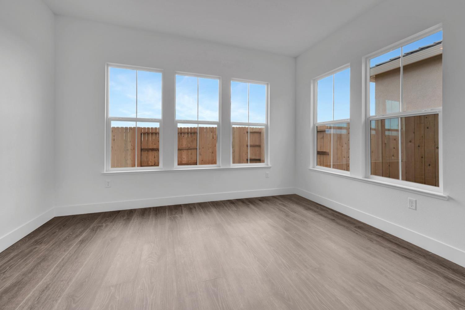 4327 Hooded Crow Way Rancho Cordova, CA 95742 - Photo 43 of 58 a view of an empty room with wooden floor and windows