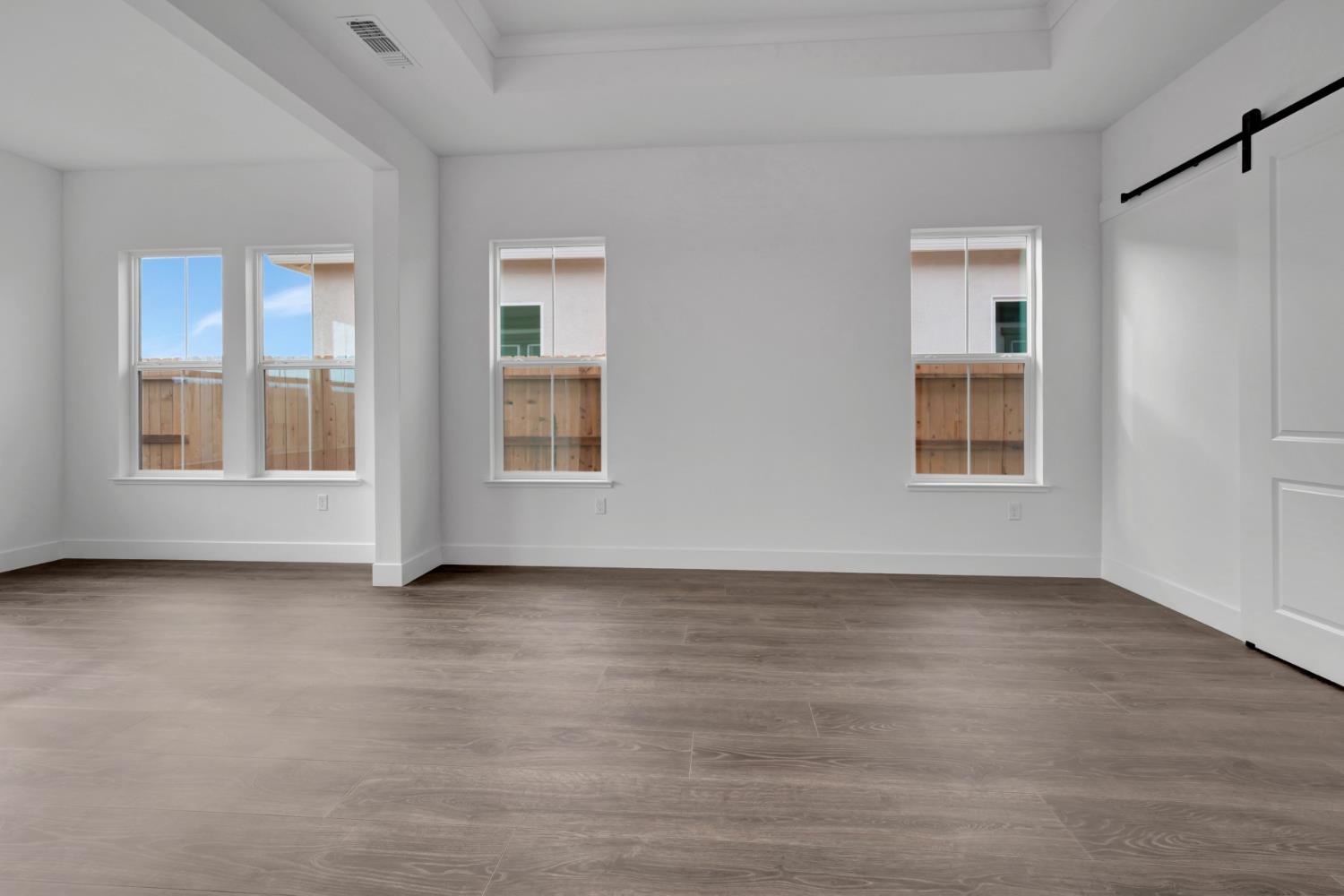 4327 Hooded Crow Way Rancho Cordova, CA 95742 - Photo 45 of 58 a view of an empty room with window and wooden floor