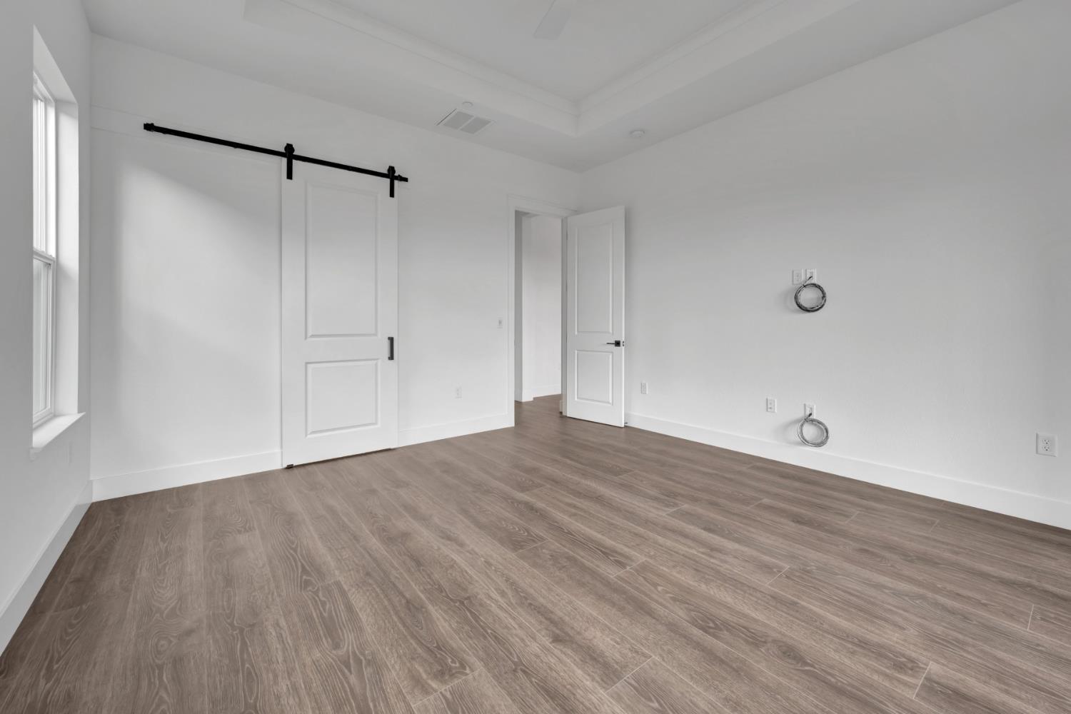 4327 Hooded Crow Way Rancho Cordova, CA 95742 - Photo 47 of 58 a view of an empty room with wooden floor