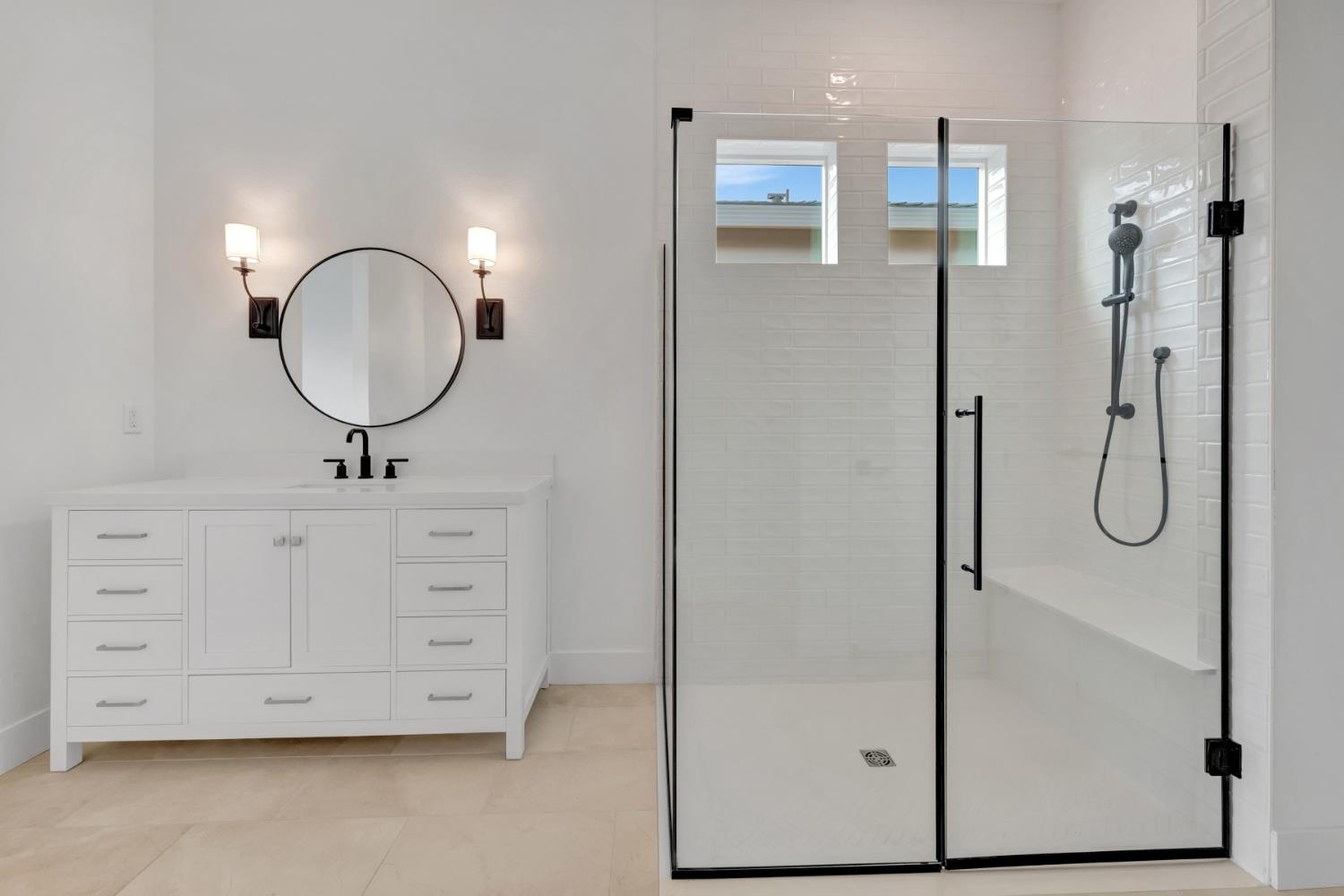 4327 Hooded Crow Way Rancho Cordova, CA 95742 - Photo 49 of 58 a bathroom with a double vanity sink a mirror and a shower