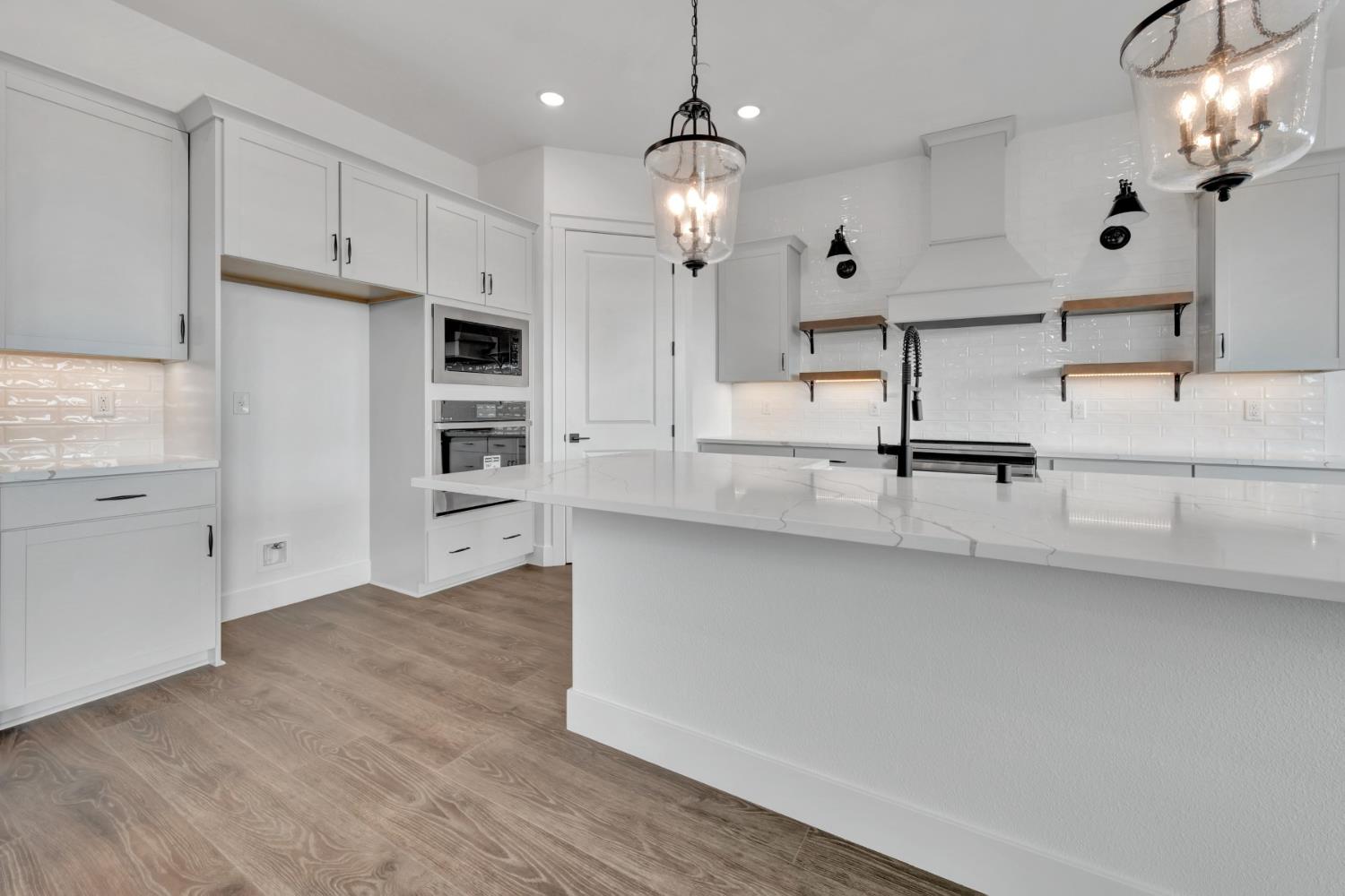 4327 Hooded Crow Way Rancho Cordova, CA 95742 - Photo 5 of 58 a kitchen with kitchen island a counter space a sink appliances and cabinets